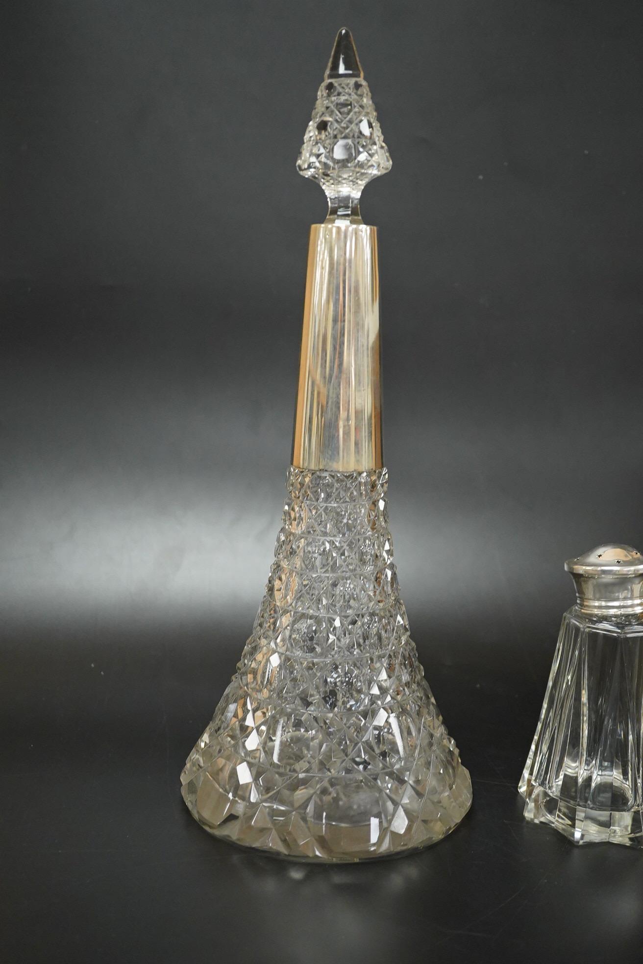 A German 800 standard white metal mounted cut glass decanter and stopper, overall height 36.5cm, together with a George VI silver mounted glass sugar caster.